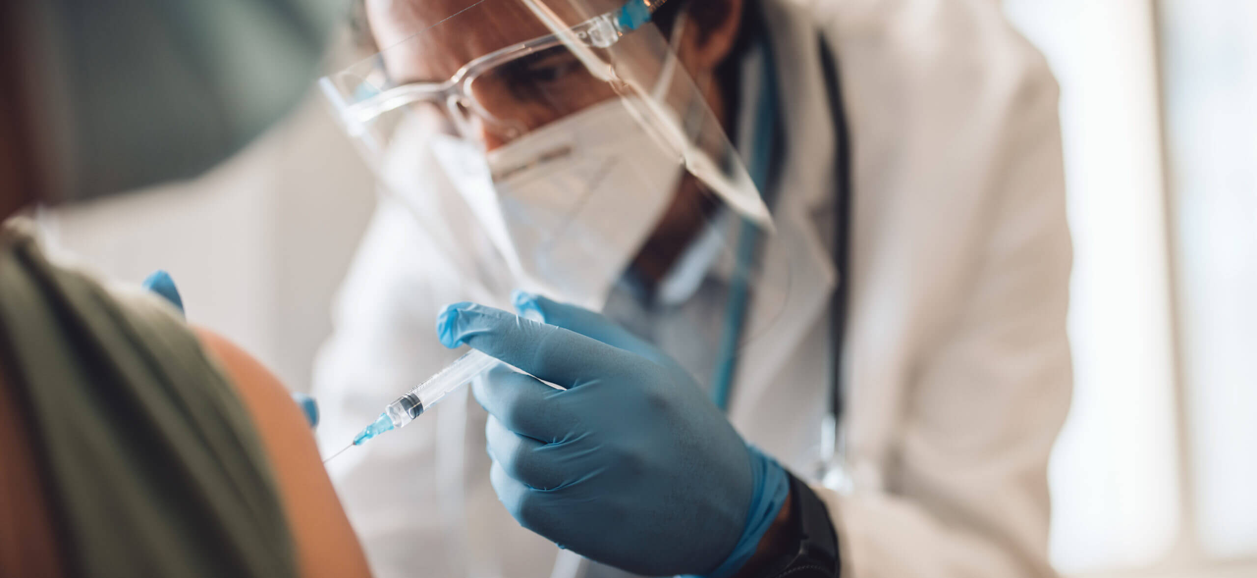medical professional administering vaccine