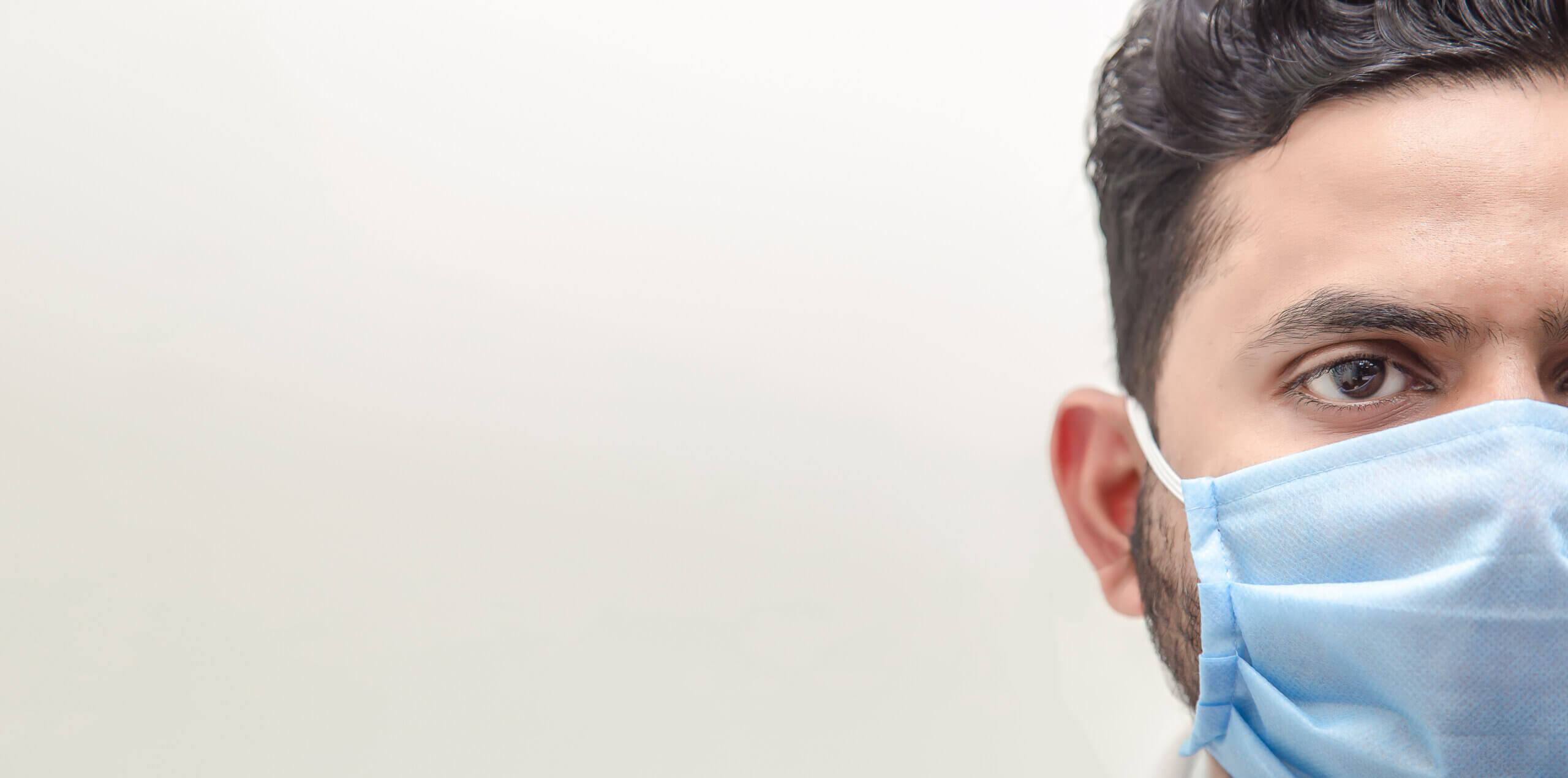 Close-up half face of a doctor wearing medical mask