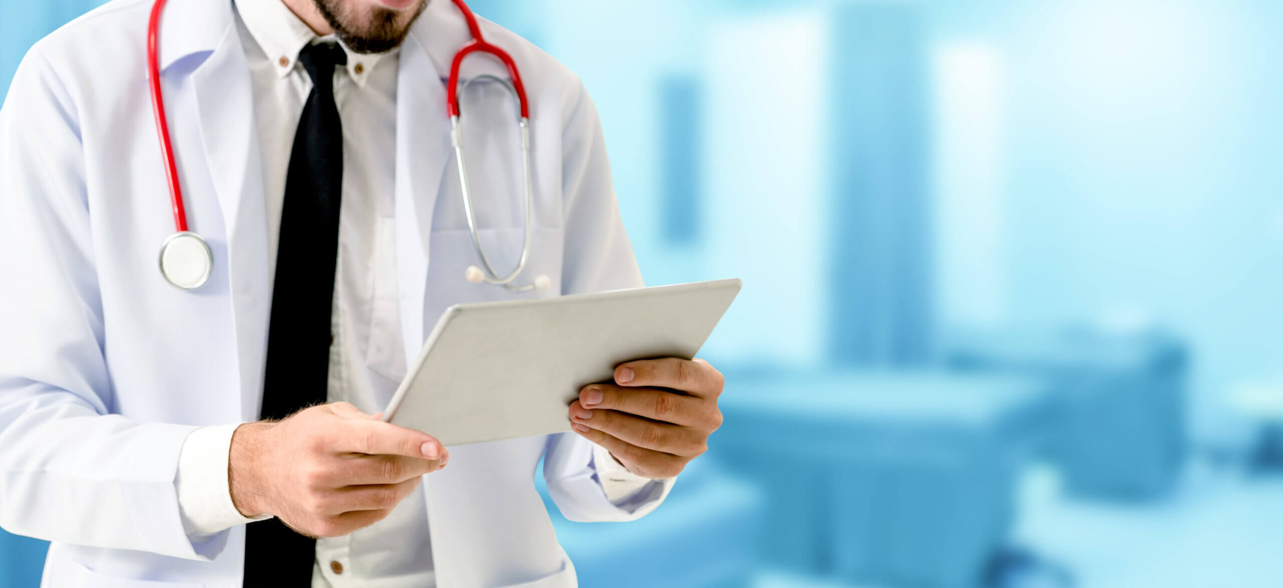 doctor reading tablet at hospital