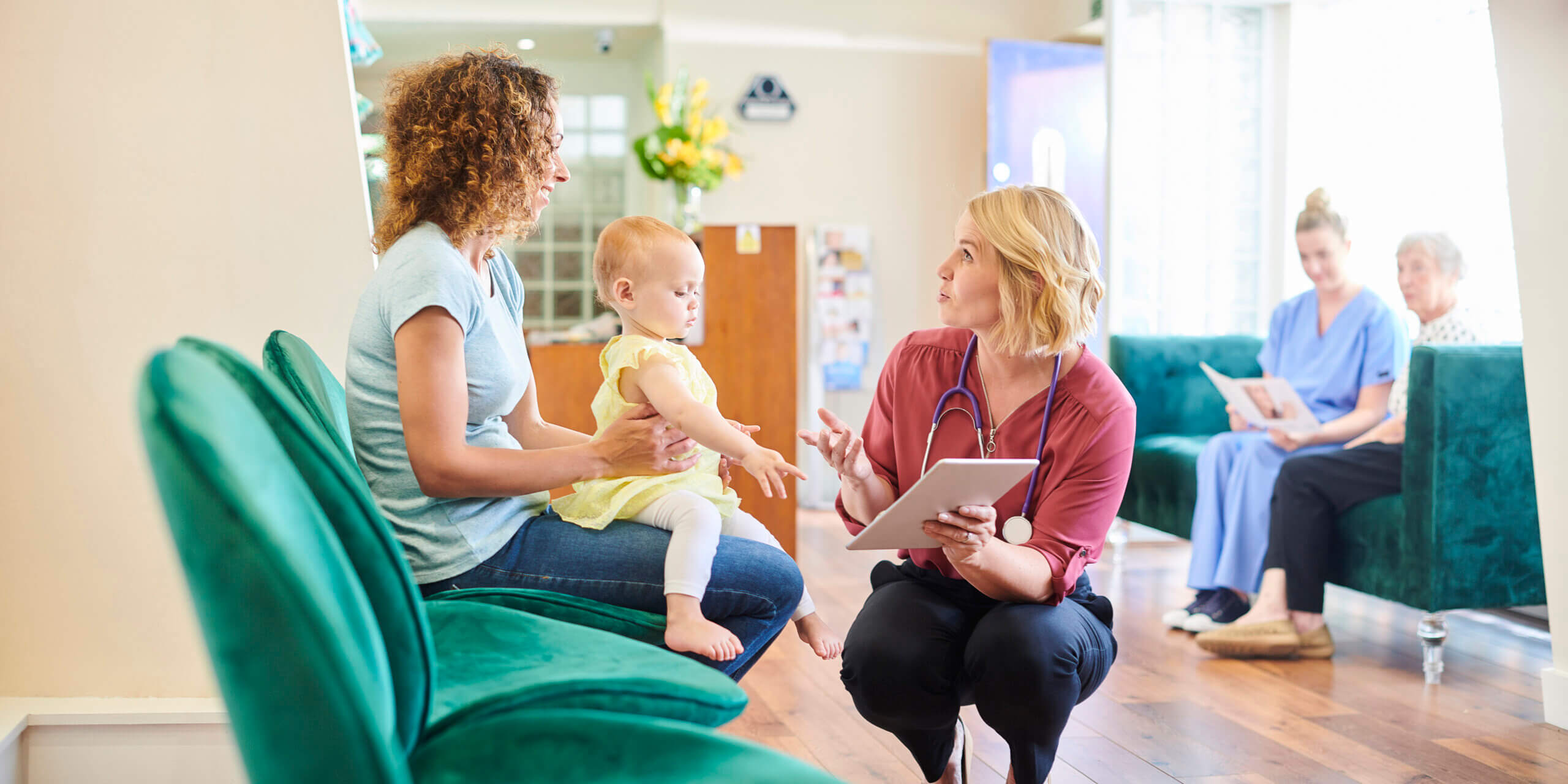 pediatrician checks in with family at the clinic