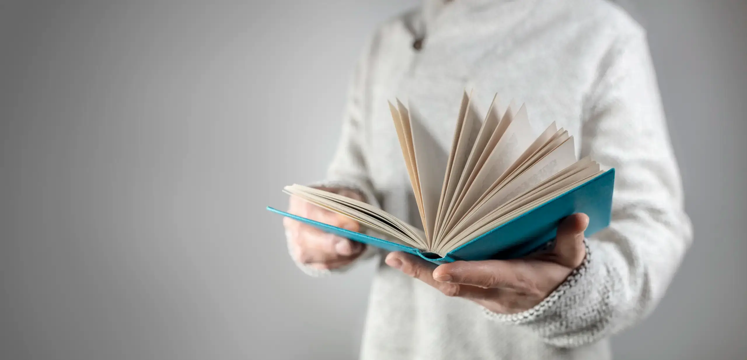 man holding book open