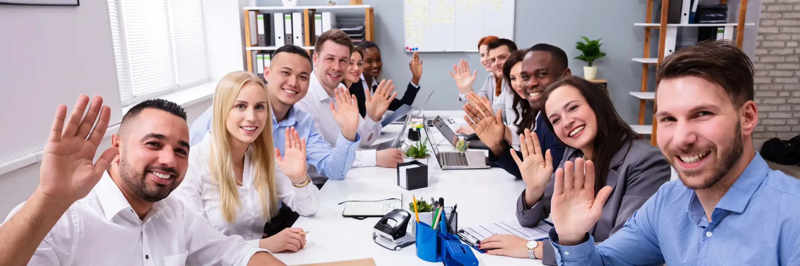 group of business people waving