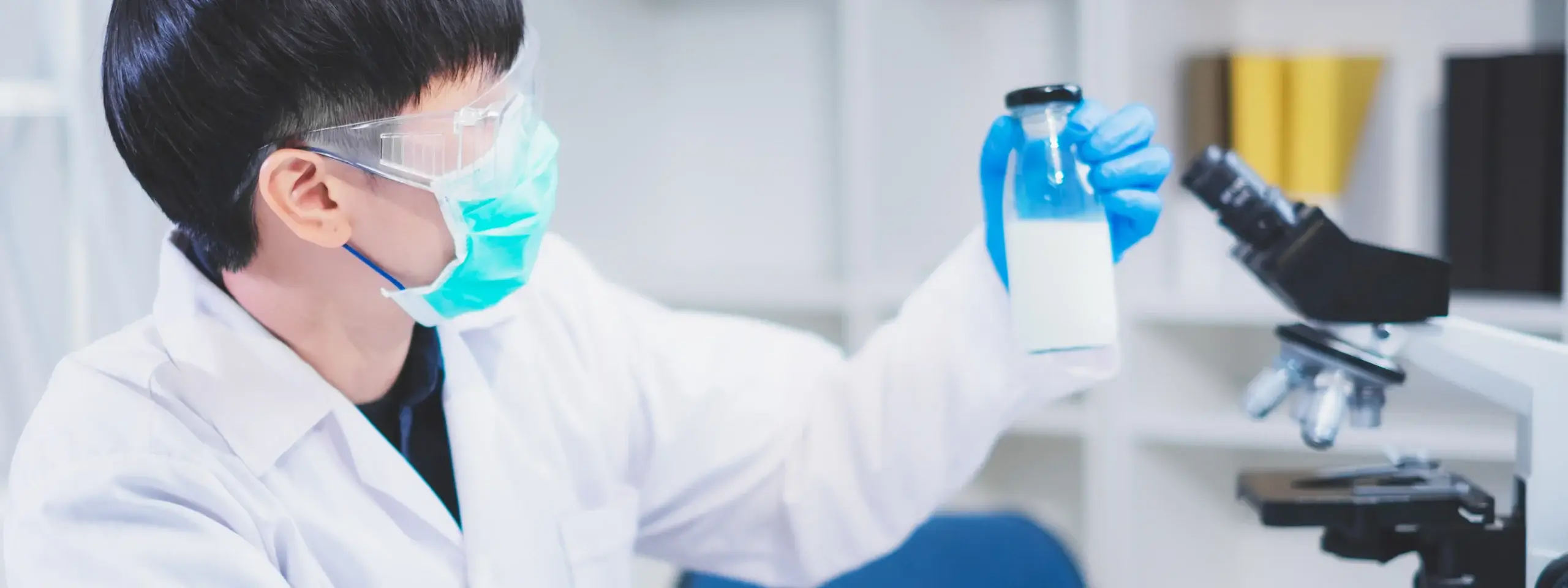Nutritionist holding milk bottle for analysis.