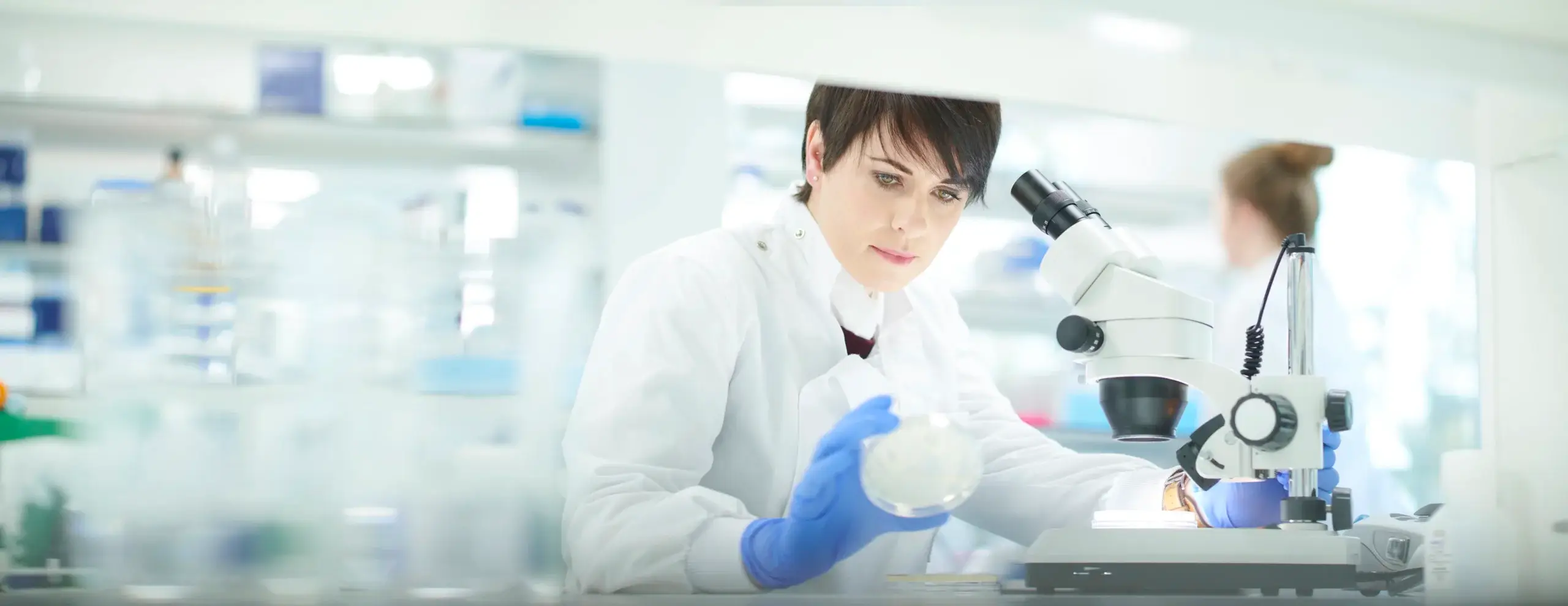 female scientist in a busy research lab