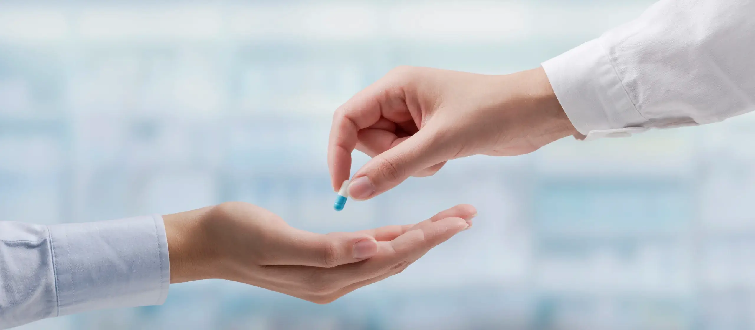 doctor handing medicine to person