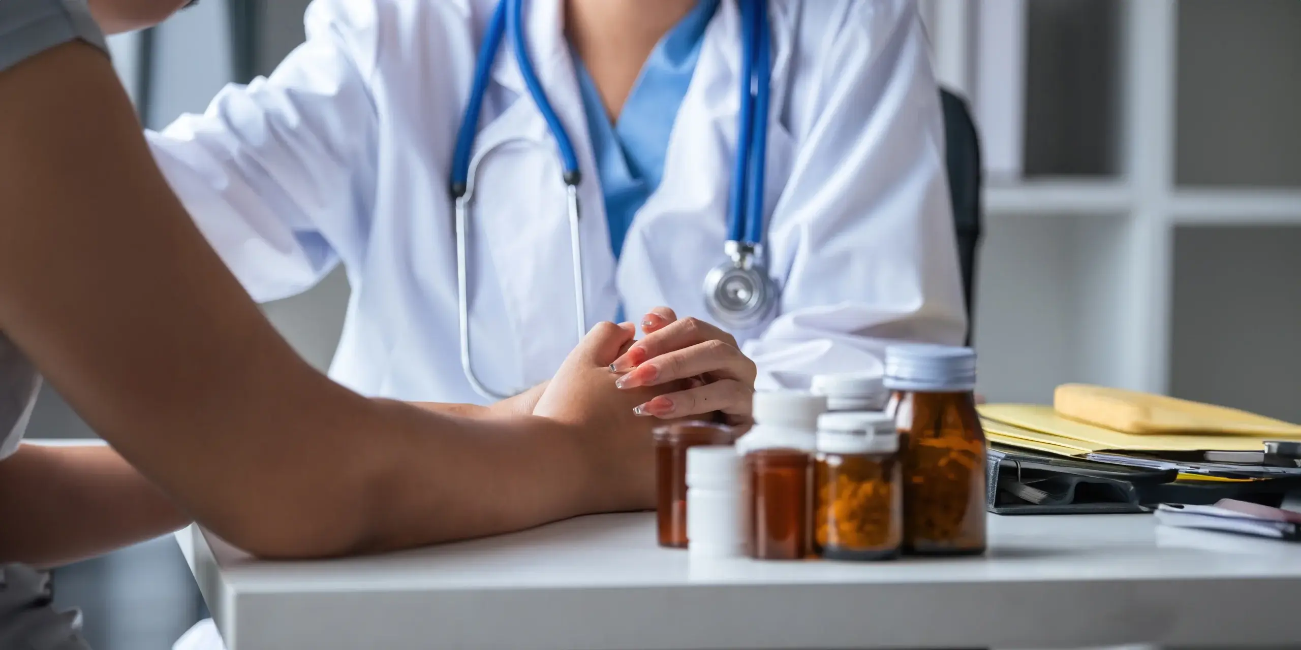 doctor holding patients hand