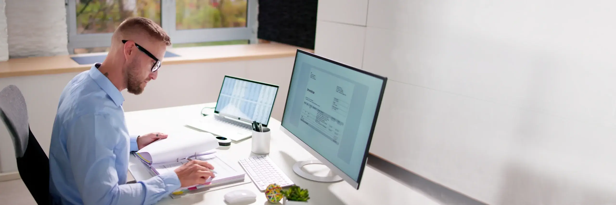 person completing audit at desk