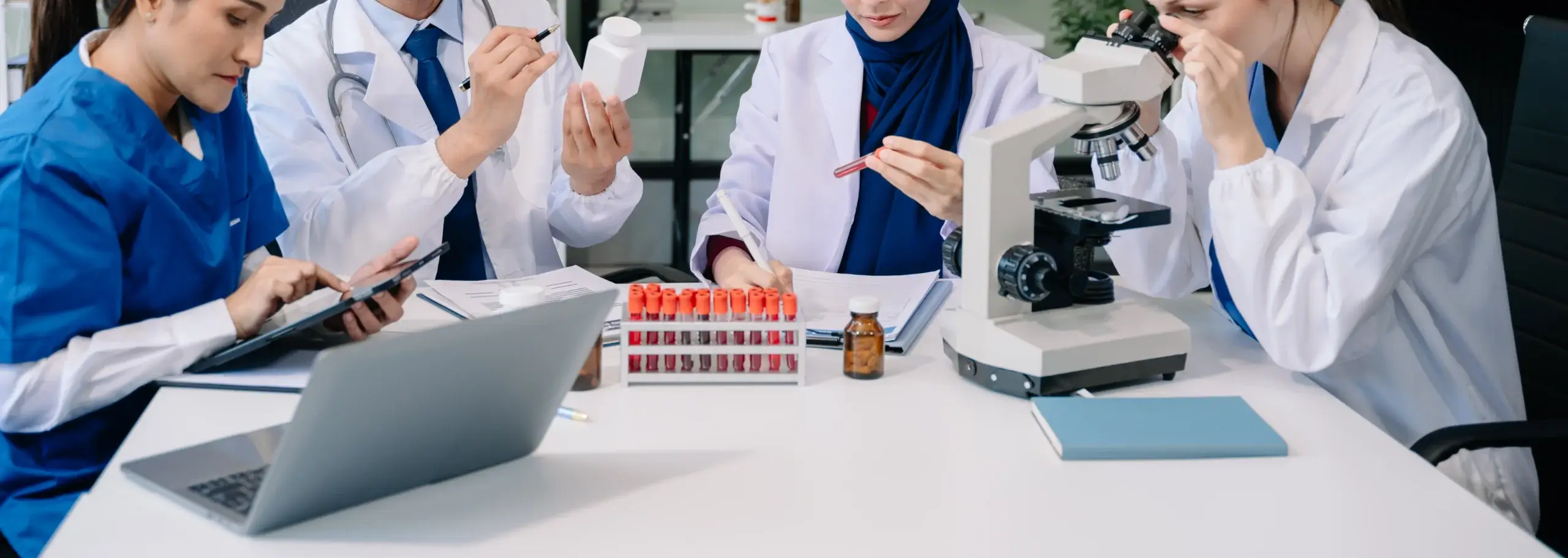 researchers examining cells in a lab
