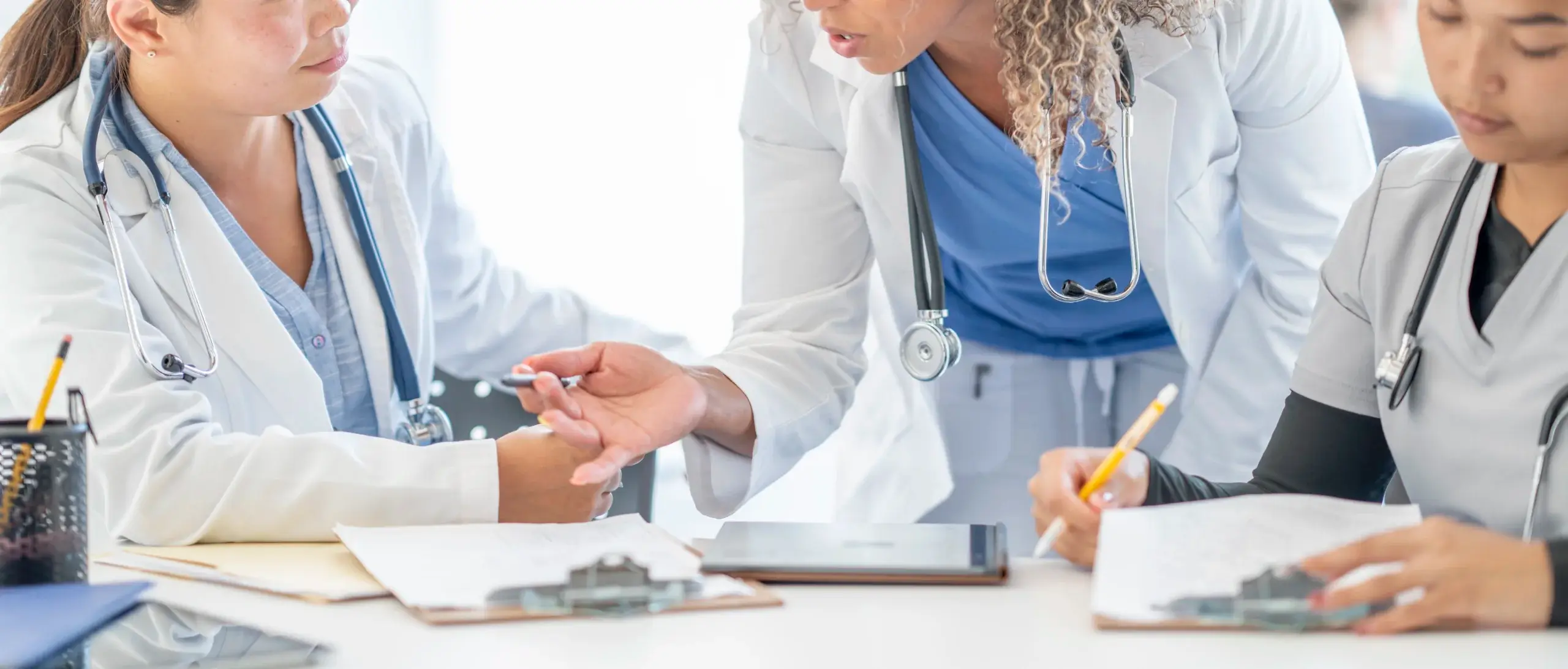 Medical team at work in discussion with one another