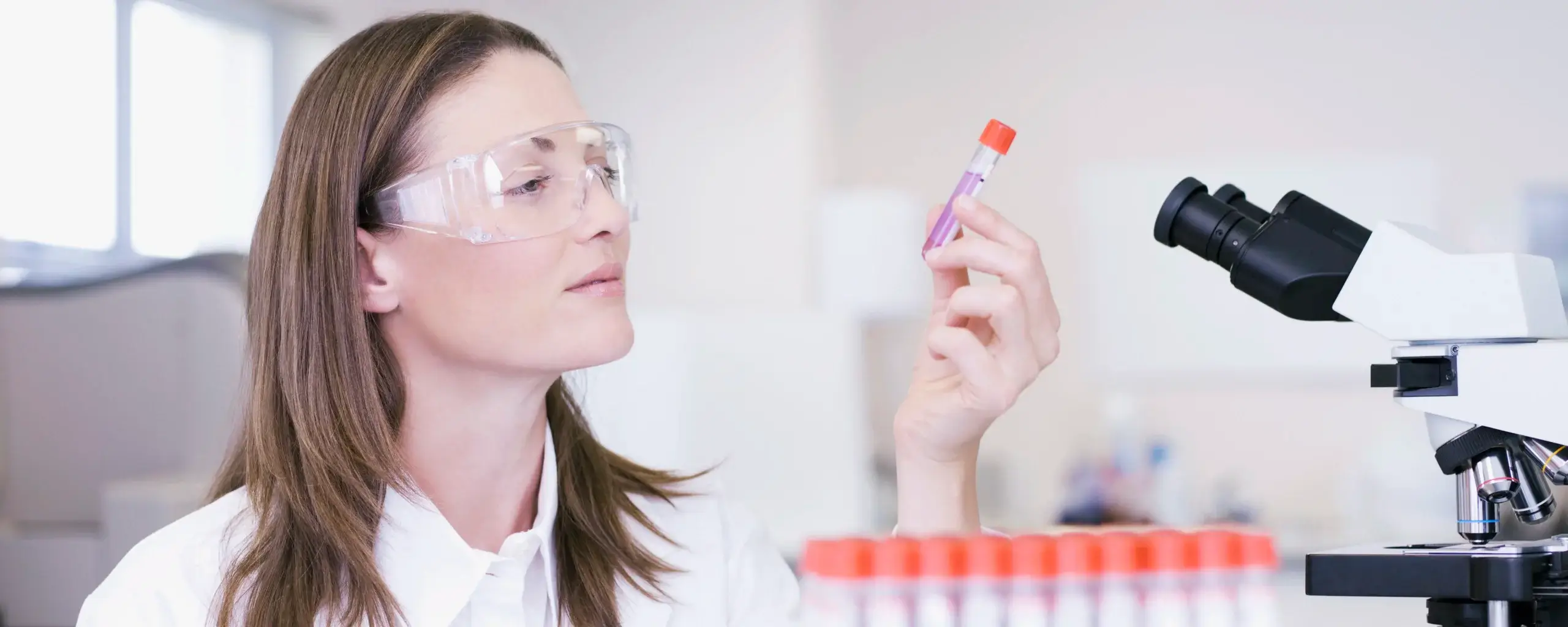 Scientist examining vial in laboratory