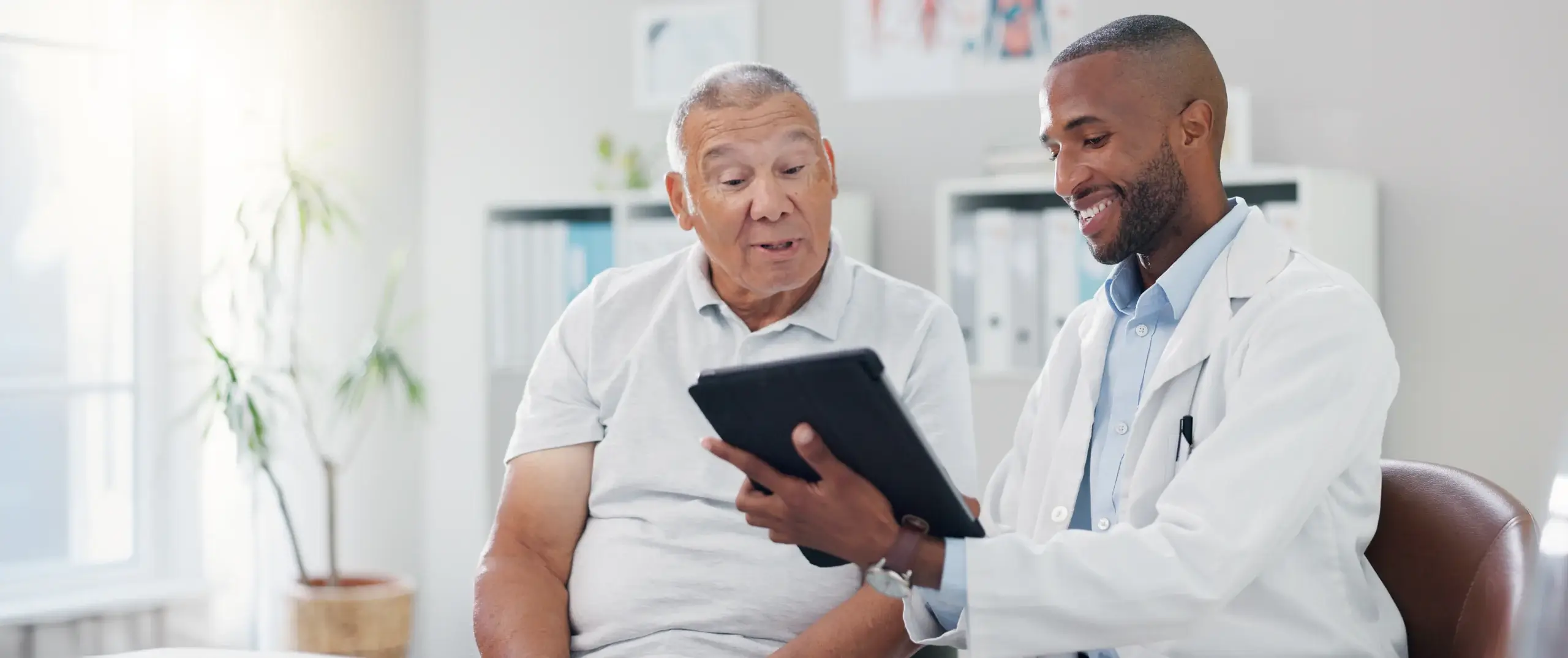 doctor talking with elderly patient